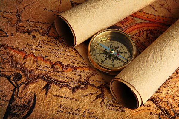 An old compass lies on old maps