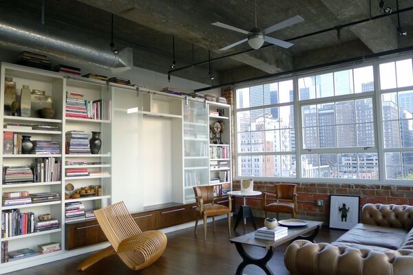 There is a white bookcase in the room with books