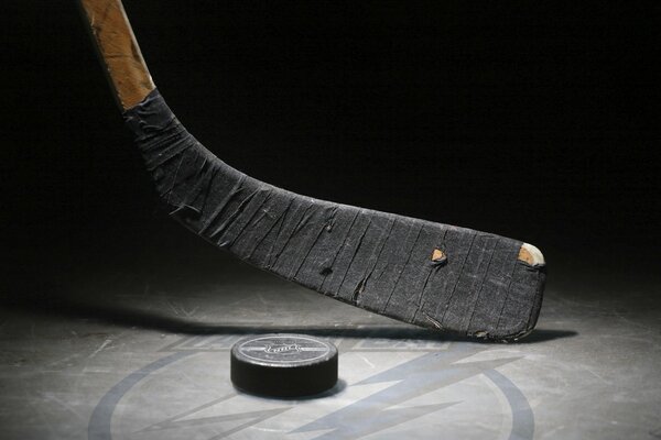 Hockey stick and puck on ice