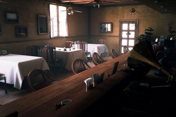 A bar counter and tables in tablecloths in a cafe