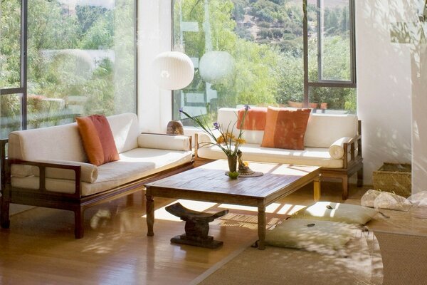 Diseño de la habitación con ventanas panorámicas. Sofá blanco en la sala de estar