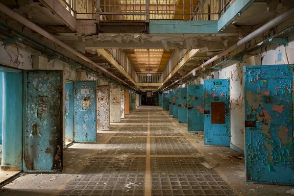 Photo of an abandoned prison. Open cell doors