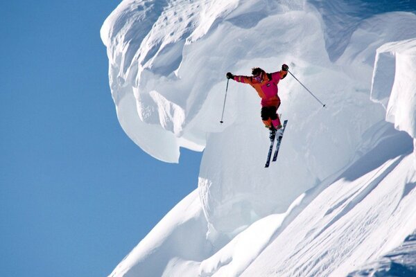 Super skier on the background of an avalanche
