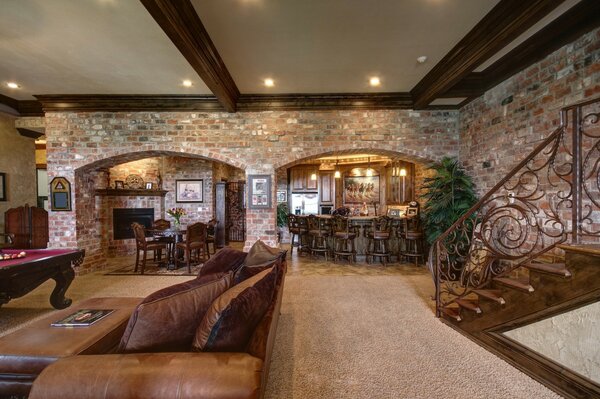 Brick and leather in the interior. Wooden staircase