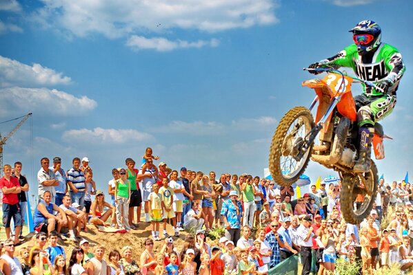 A cool stunt of a motorcyclist at a race