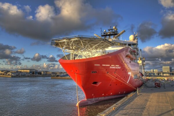 The red yacht is moored