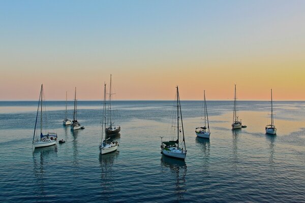 Ships are at sea during a blue sunset