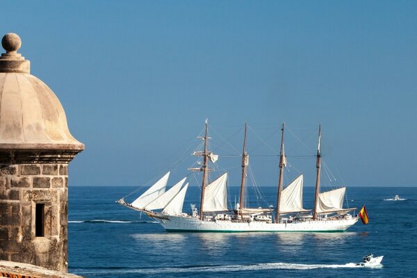 The boat plows the sea water coast