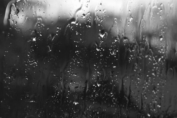 Black and white picture, glass in raindrops