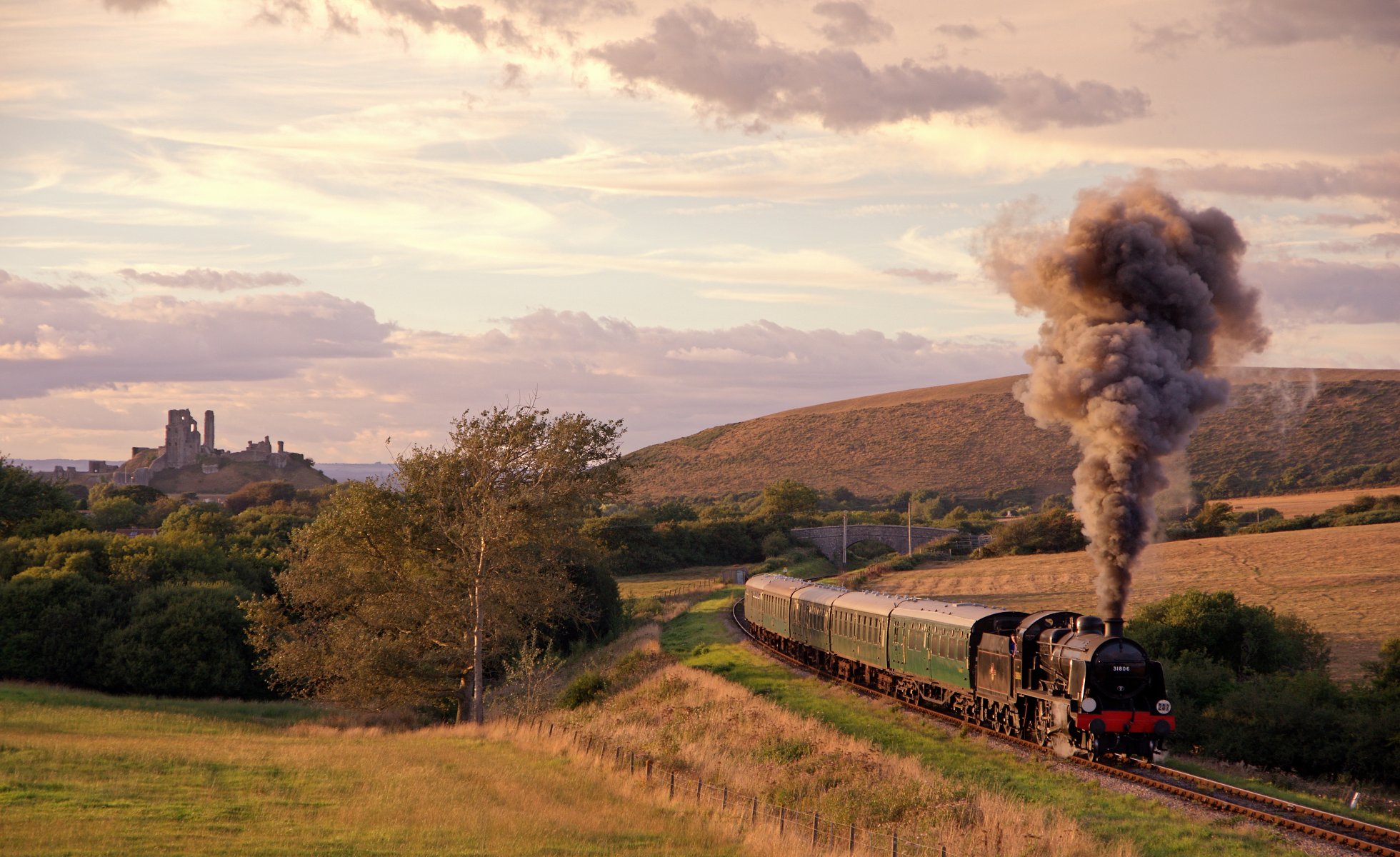 railroad the way train steam engine smoke cars meadows of the field uplands ruins of corfe castle united kingdom