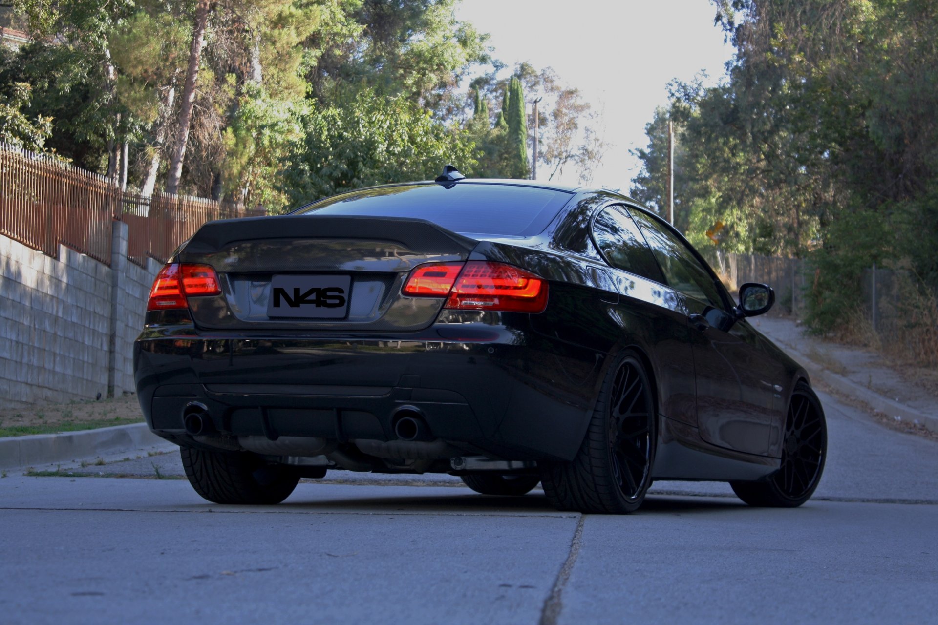 bmw 335i black bmw rear headlights trees sky