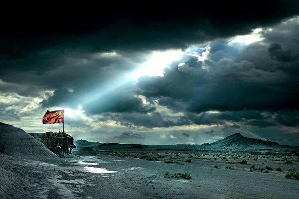 Flagge in der Wüste durch Sonnenlicht beleuchtet