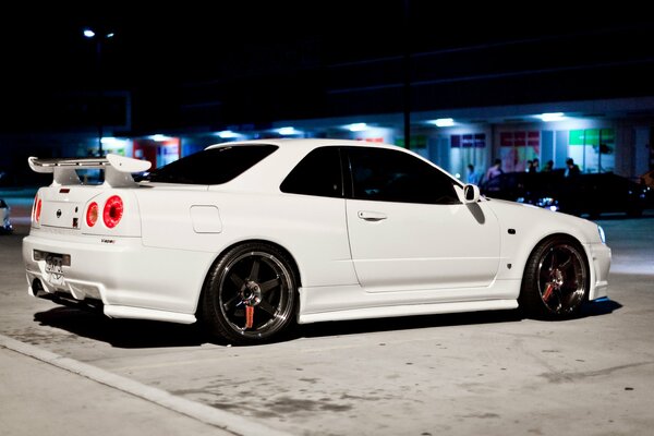 White tuned Nissan in the night city