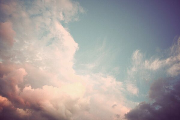 Delicate pink sky with white clouds