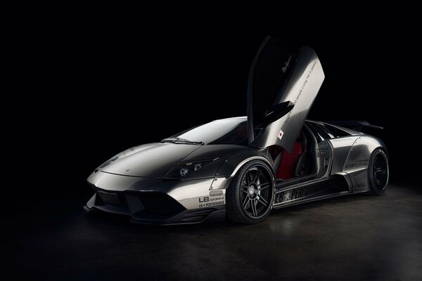 Supercar on a black background with an open door