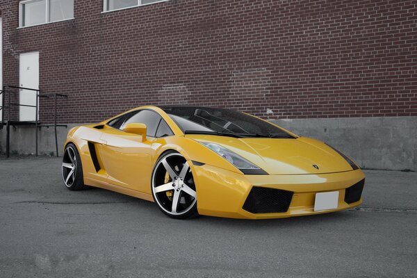 Sports car on the background of a brick wall