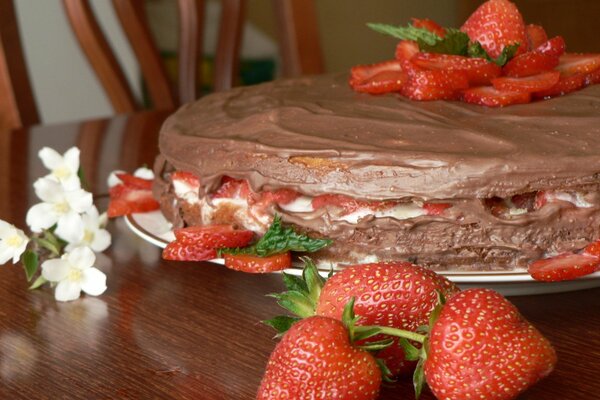 Dessert of strawberries and chocolate on a wooden table