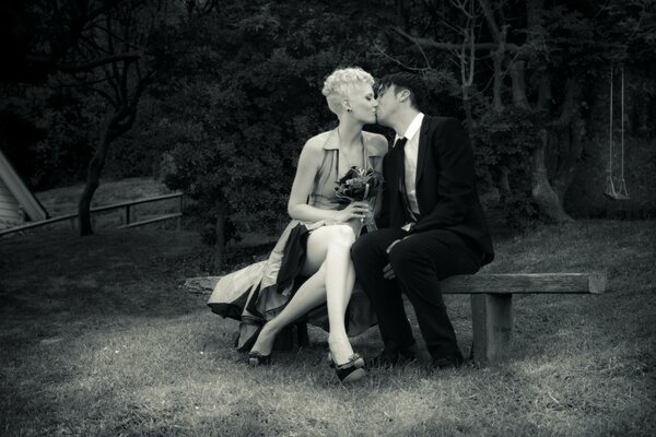 Romantic kiss on a park bench