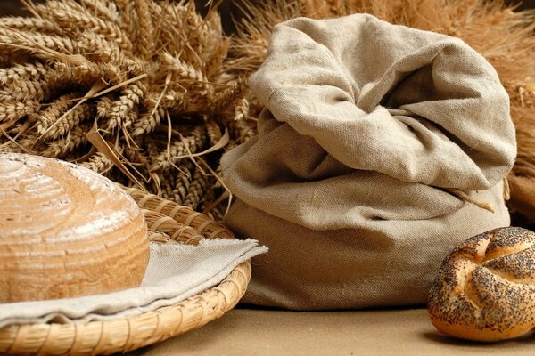 Bread with a linen bag on the background of spikelets