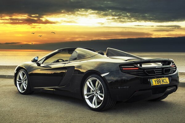 The back of a beautiful McLaren car in the sunset