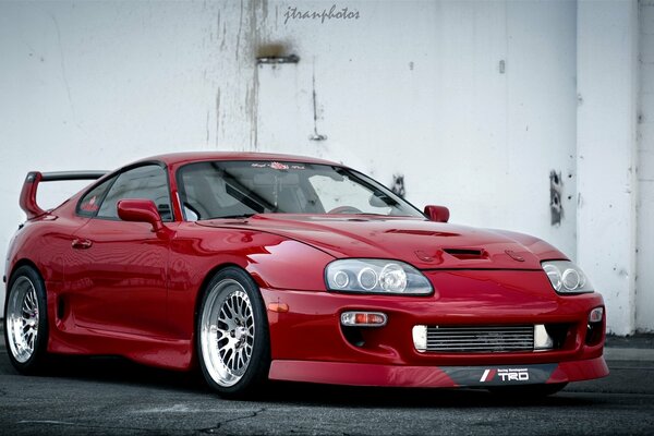 Red car on a white wall background