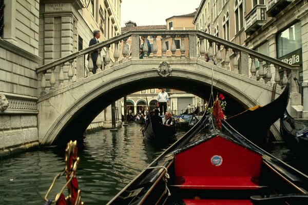 Gandola swims across the bridge in Venice