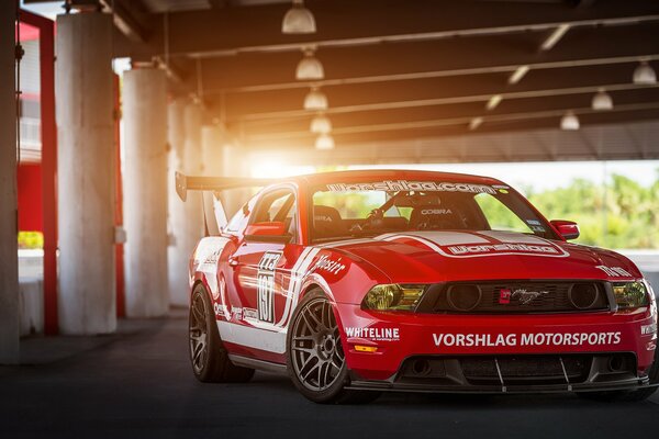 Red Ford Mustang in the parking lot