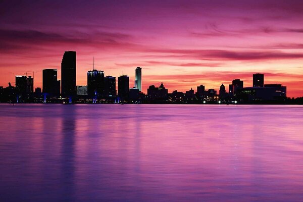 The city on the background of a pink sunset