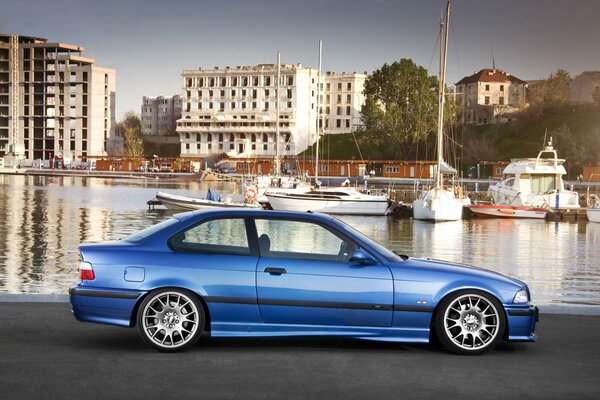 Blue car on the shore of the pier