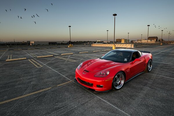 Red chevrolet corvette in the parking lot