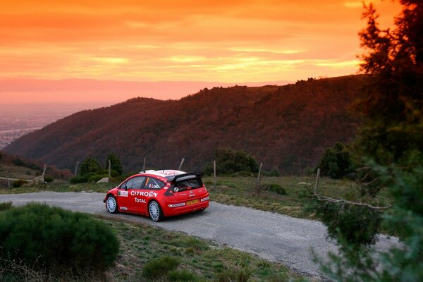 Red citroen c4 and sunset in the mountains