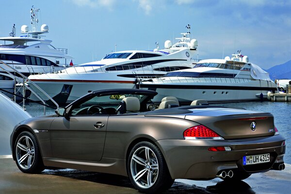 Bmw convertible. the color is metallic gray. car at the pier