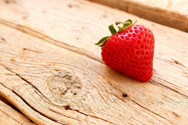 Juicy strawberries on a wooden table