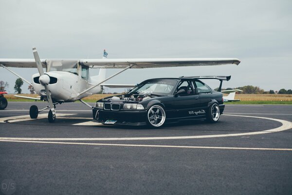 BMW-Auto in der Nähe des Flugzeugs auf der Startrampe