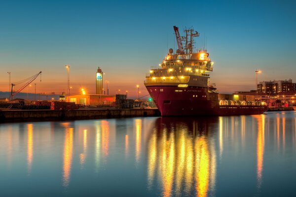 The barge is moored in the night light