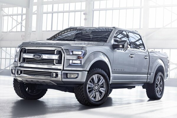 The front of a gray Ford in a light hangar