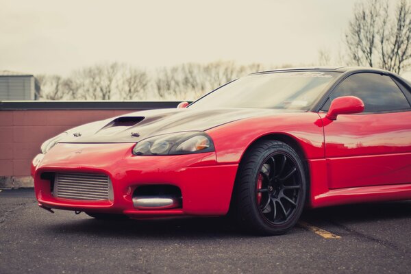 A red Mitsubishi was parked in the red parking lot