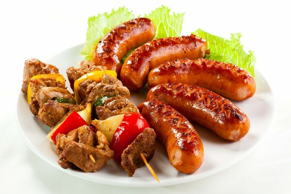 Fried sausages and shish kebab with herbs