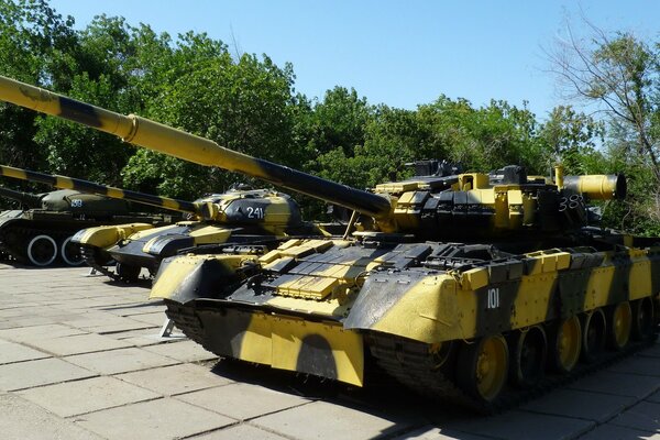 Russian tanks on the background of green trees