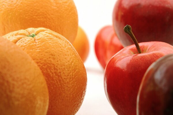 Orange oranges on the left and red apples on the right