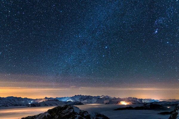 Starry sky and snowy mountains