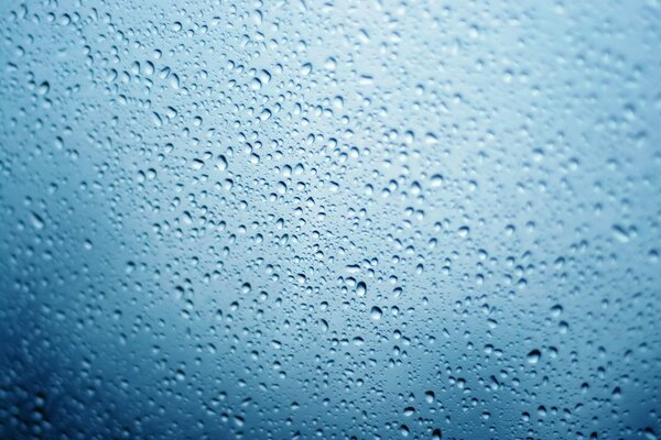 Small drops of water on a blue background