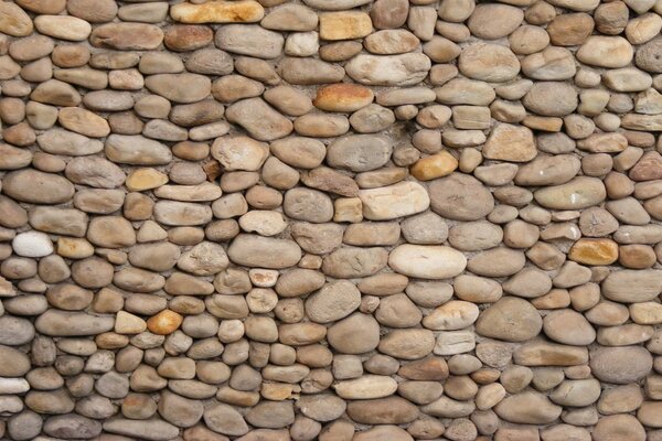 A wall of oval brown stones