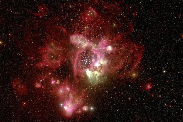 Nebulosa de color rojo en el fondo de las estrellas del universo