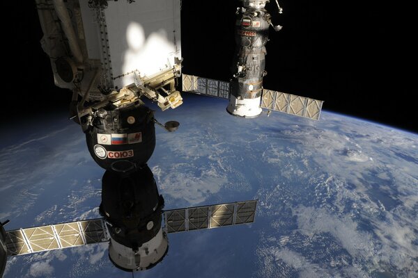 The Soyuz Progress spacecraft is flying in the orbit of the planet earth
