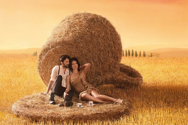 Romantic couple on the background of haystacks