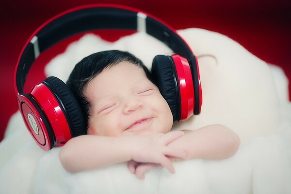 Cute baby listening to music with headphones