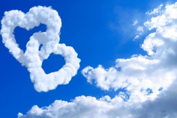 Clouds in the shape of intertwined hearts on the sky background