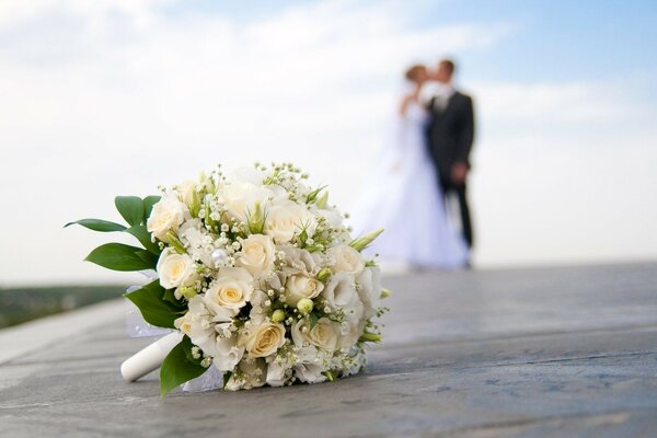 Wedding photo of the newlyweds with a bouquet