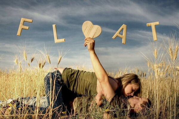 Romantic couple kissing in the field